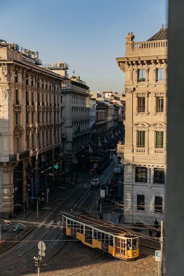 a street with buildings and a tram