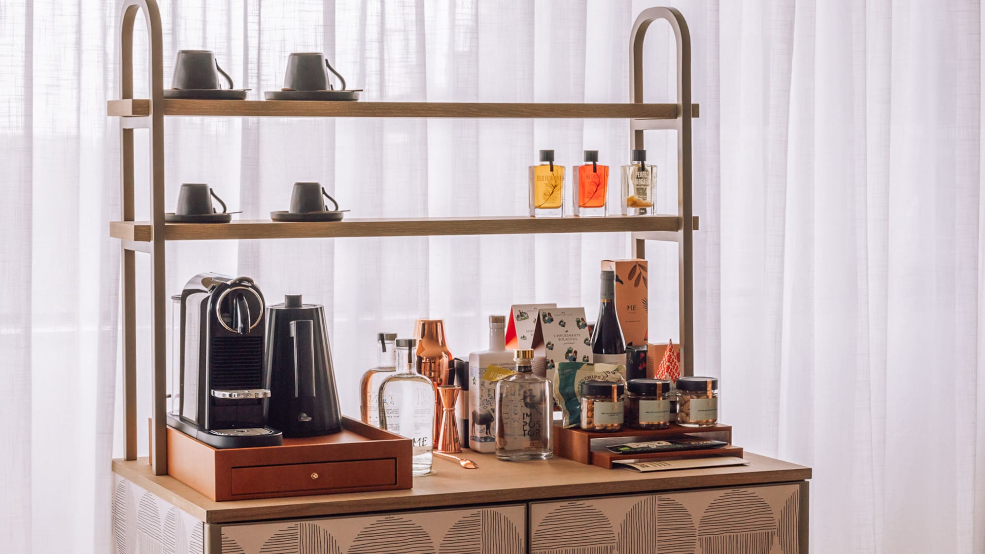 a counter with a shelf and coffee maker