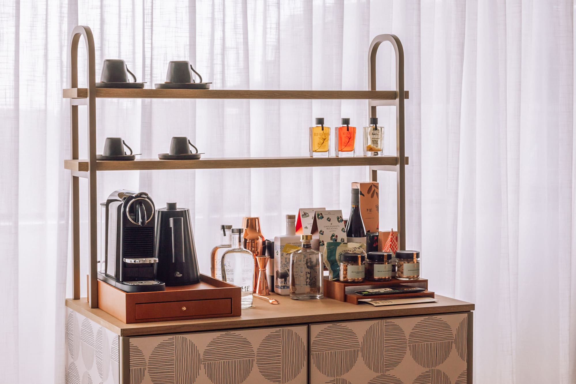 a counter with a shelf and coffee maker