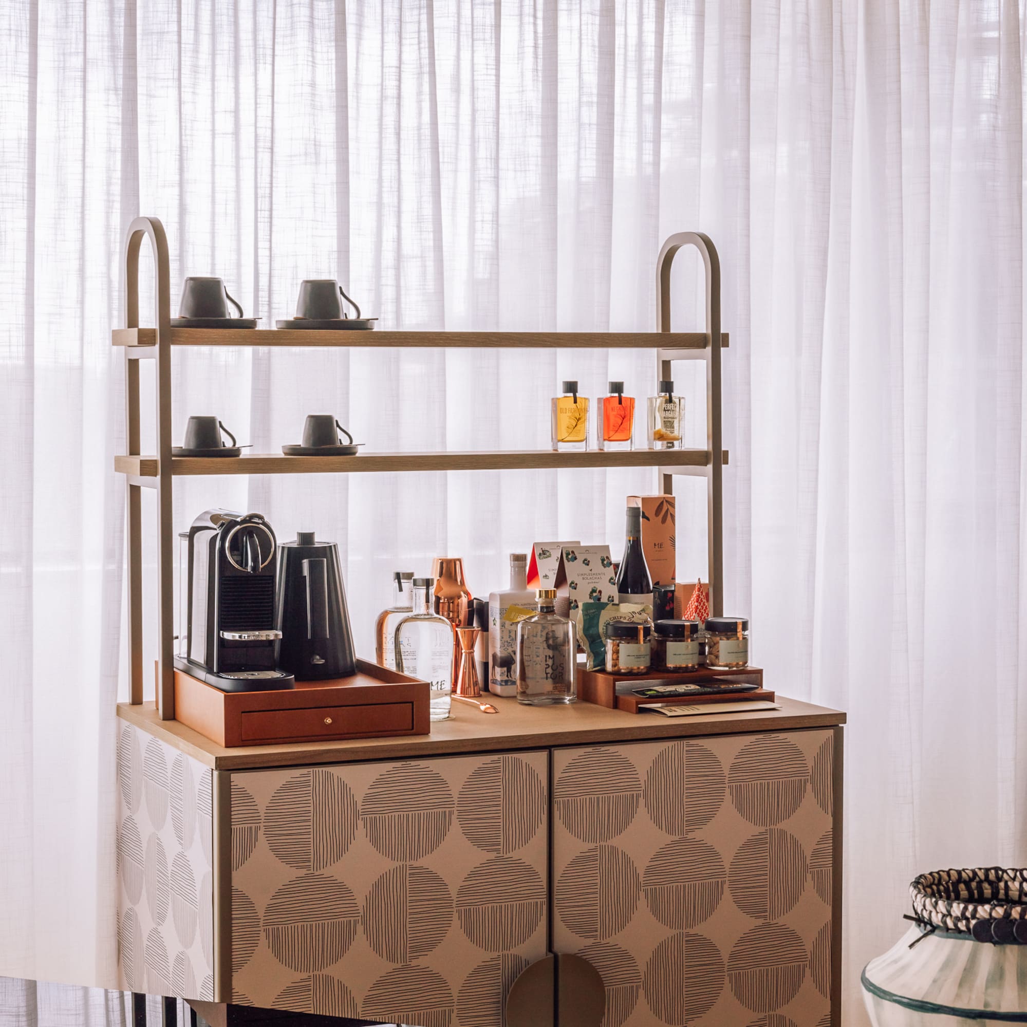 a counter with a shelf and coffee maker