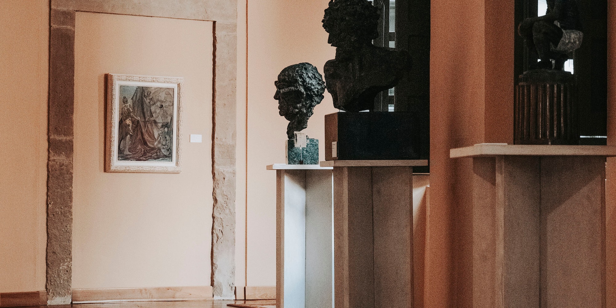 a hallway with statues on the shelves