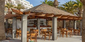 a patio with tables and chairs