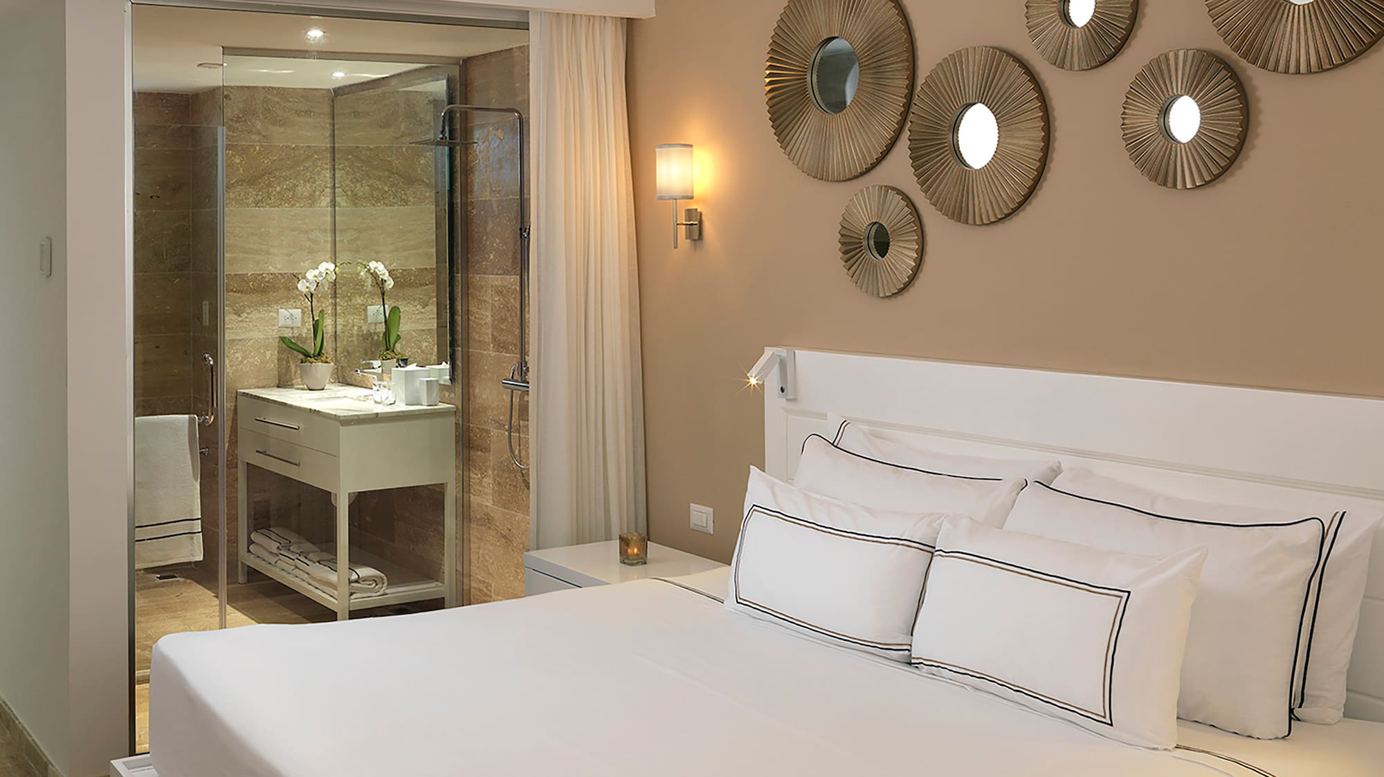 a bed with white sheets and a ceiling fan