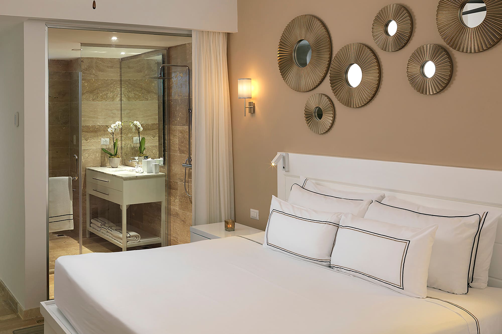 a bed with white sheets and a ceiling fan