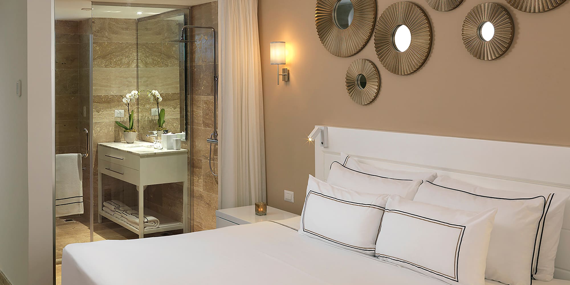 a bed with white sheets and a ceiling fan