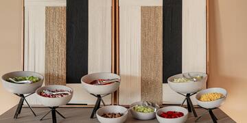 a buffet table with bowls of food