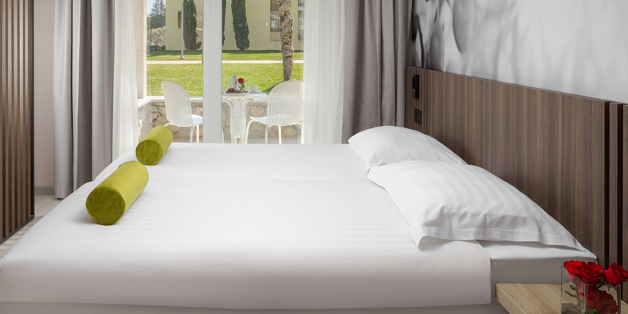 a bed with white sheets and pillows