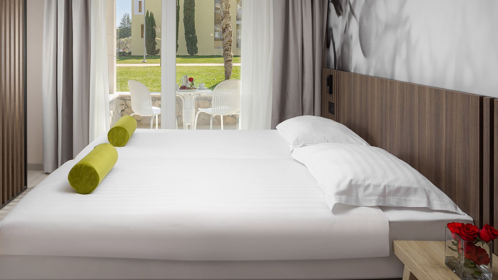 a bed with white sheets and pillows