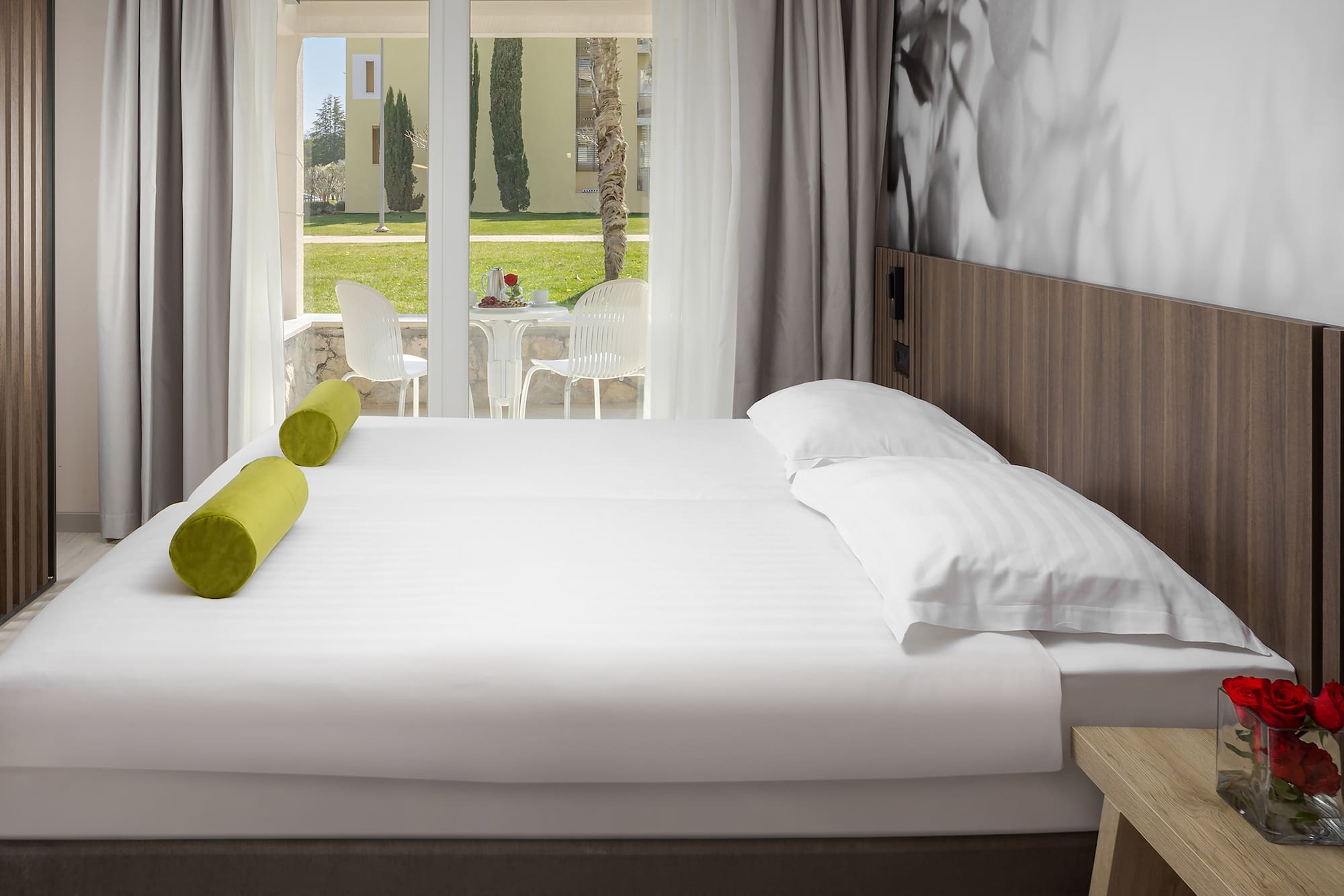 a bed with white sheets and pillows