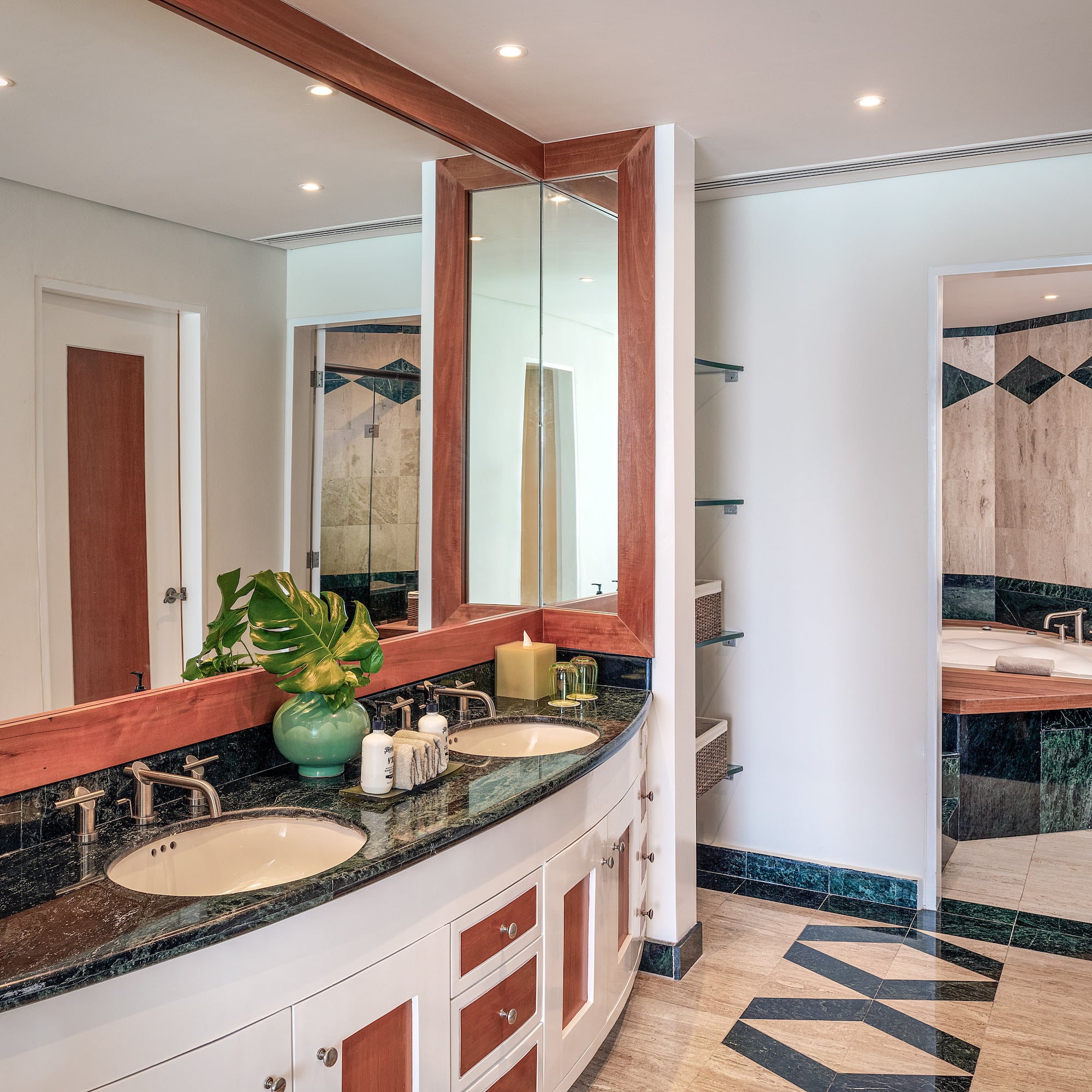 a bathroom with a large mirror and a sink