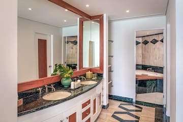 a bathroom with a large mirror and a sink
