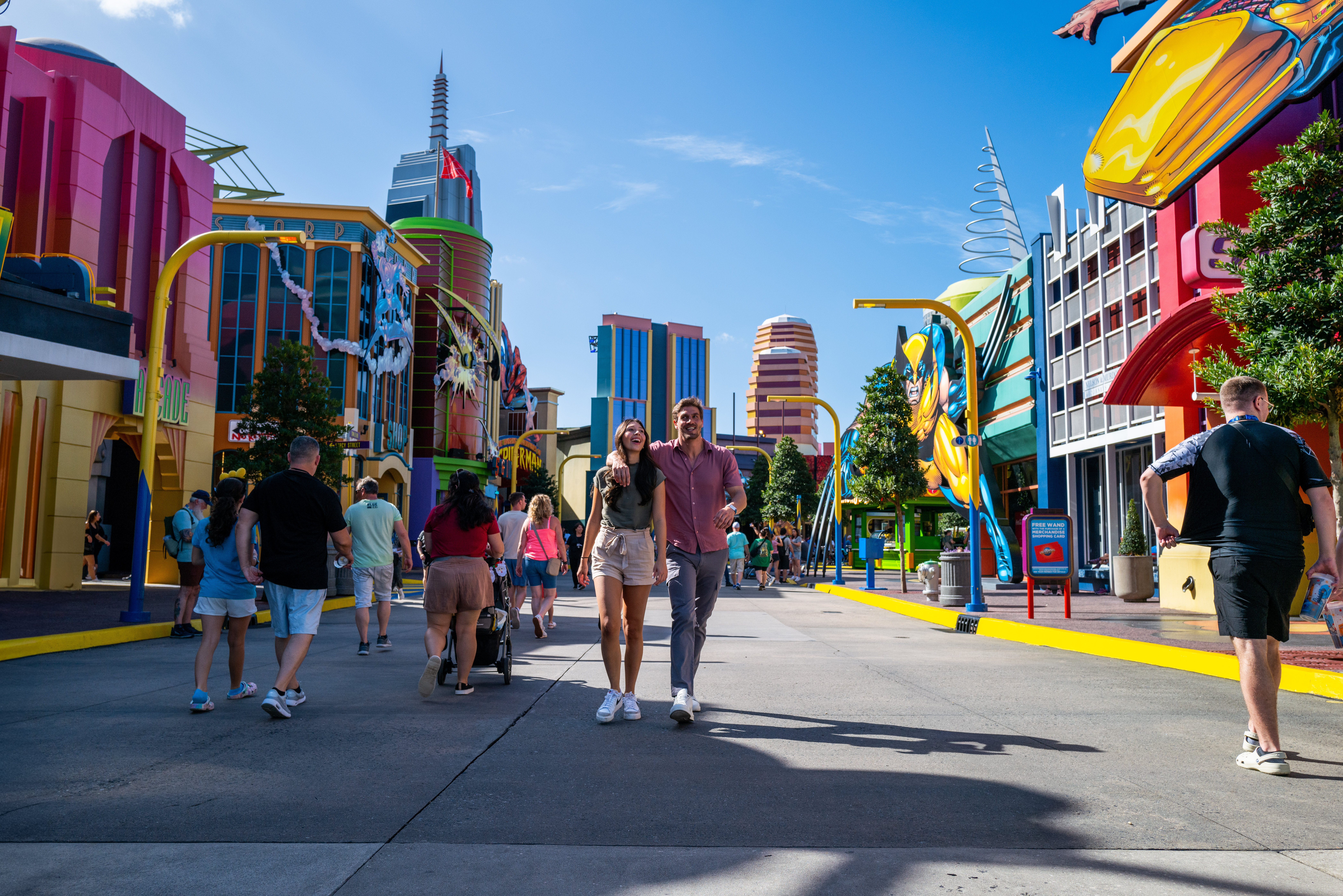 a man and woman walking in a street with colorful buildings