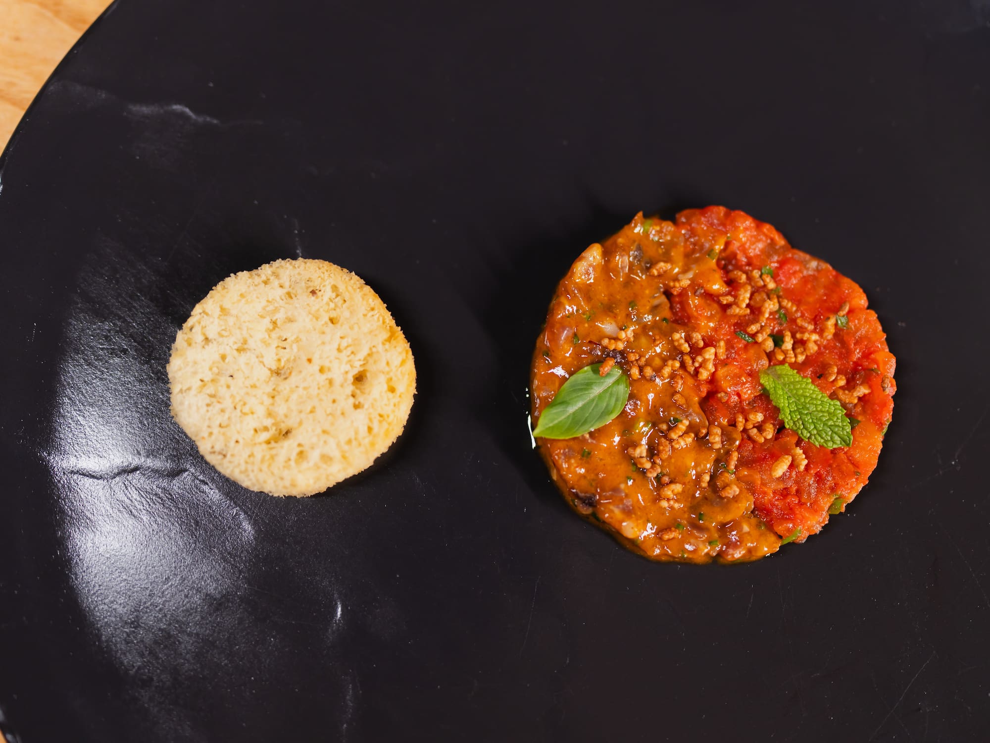 a round biscuit next to a round red food item