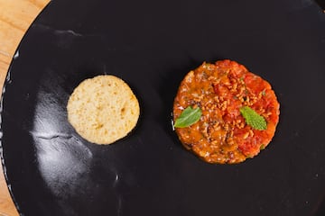 a round biscuit next to a round red food item