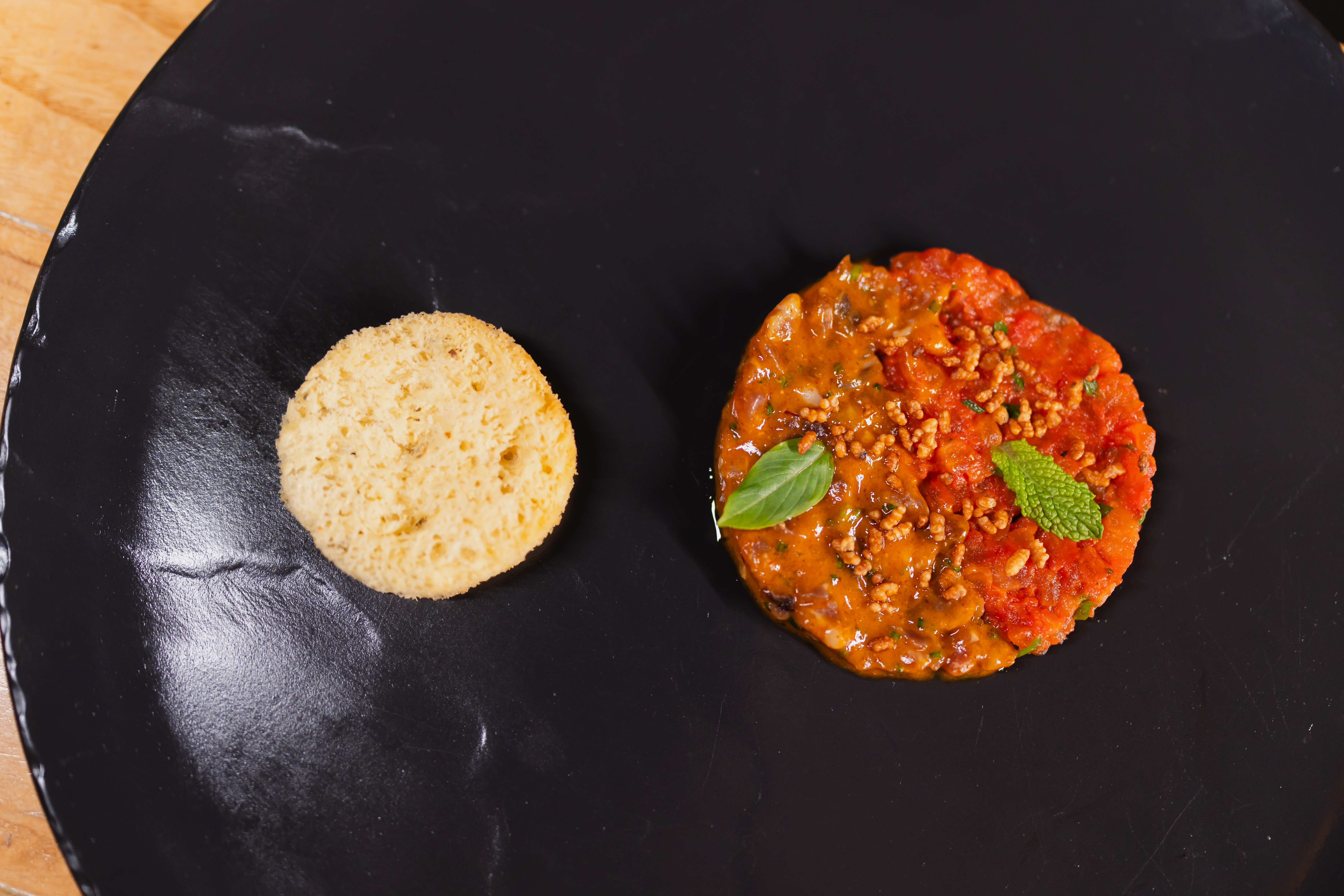a round biscuit next to a round red food item