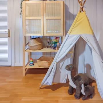 a toy tent and stuffed animals in a room