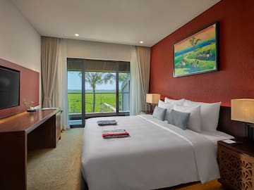 a bedroom with a large bed and a window