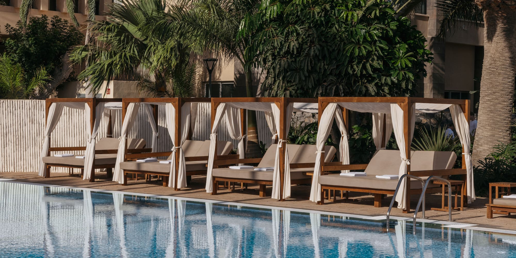 a pool with lounge chairs and canopy