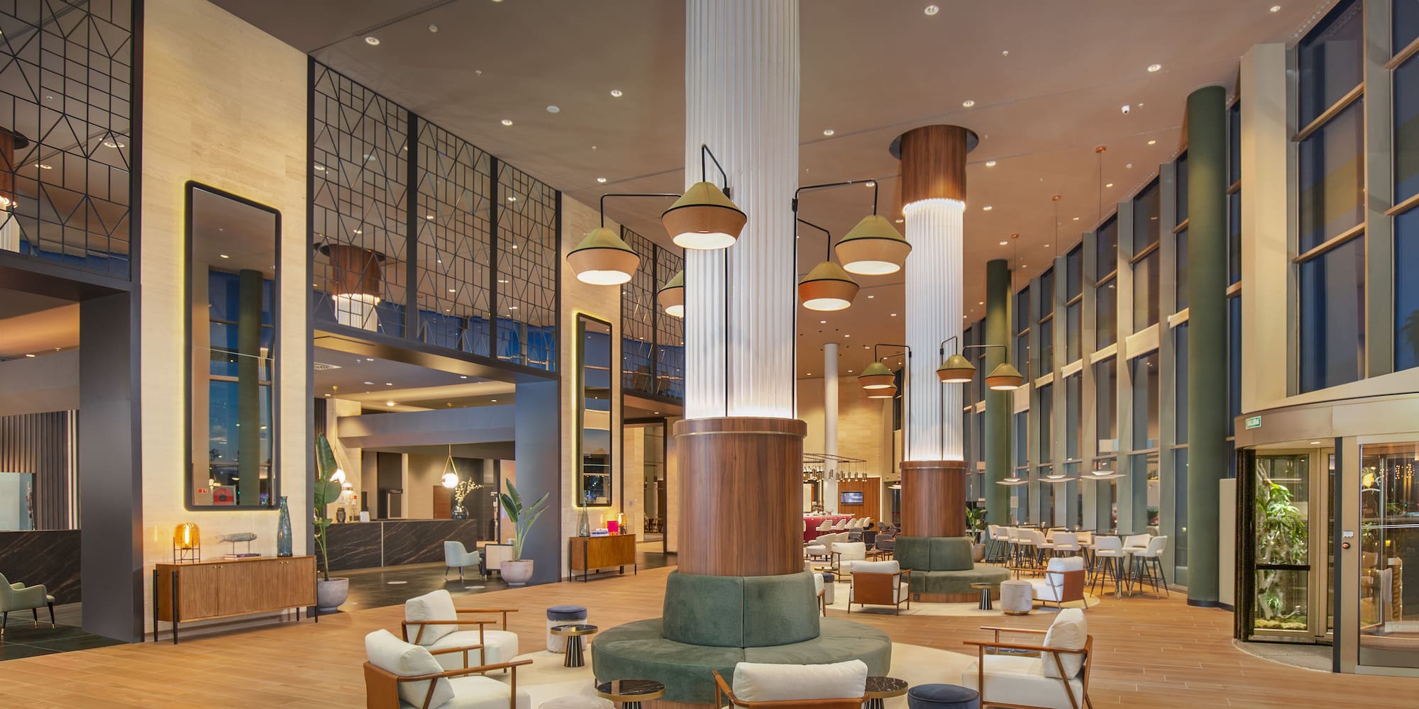 a large lobby with a large column and chairs