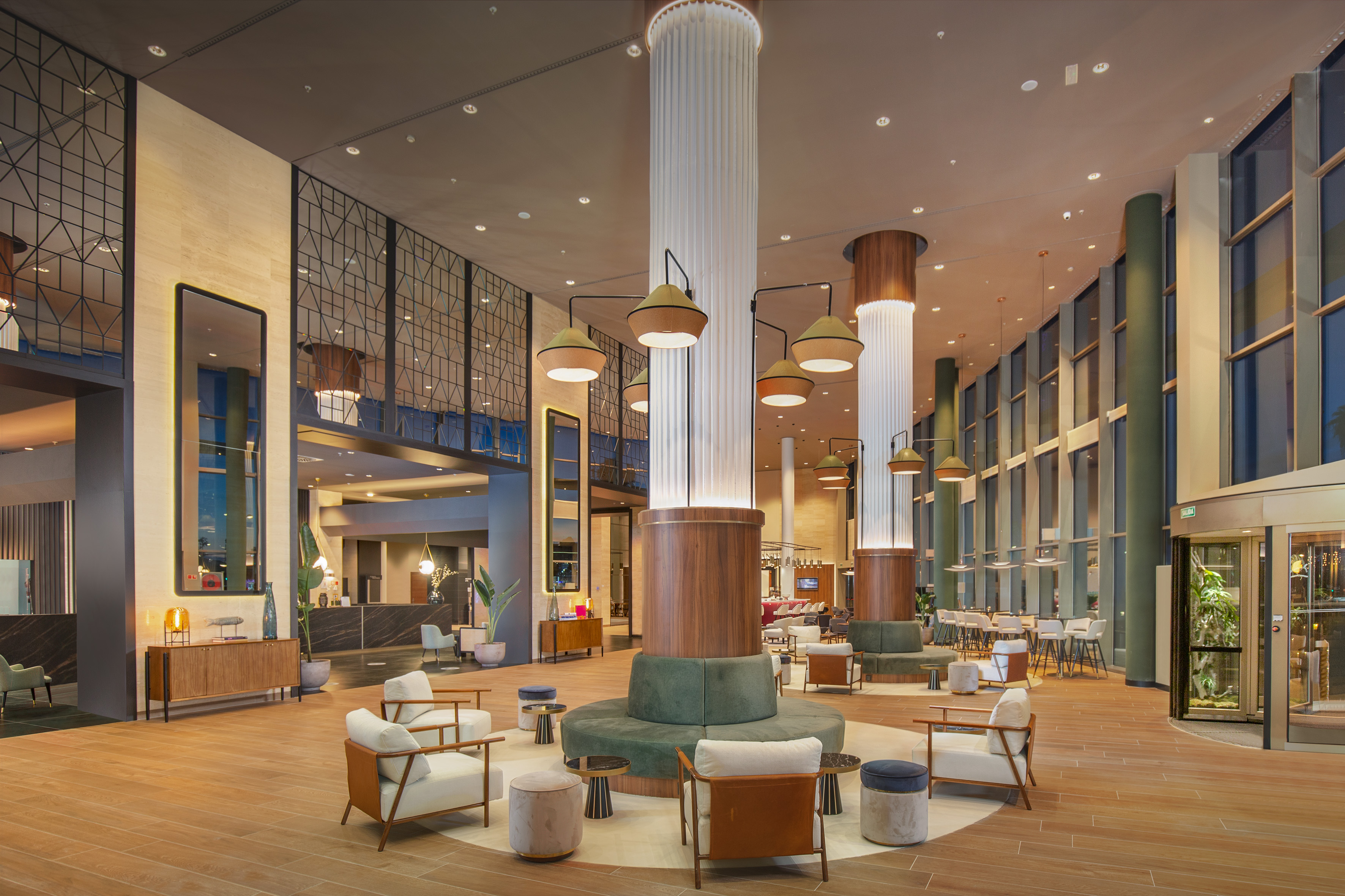 a large lobby with a large column and chairs