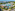 Aerial of Aquazone water park, resort pools, modern hotel buildings, tropical setting.