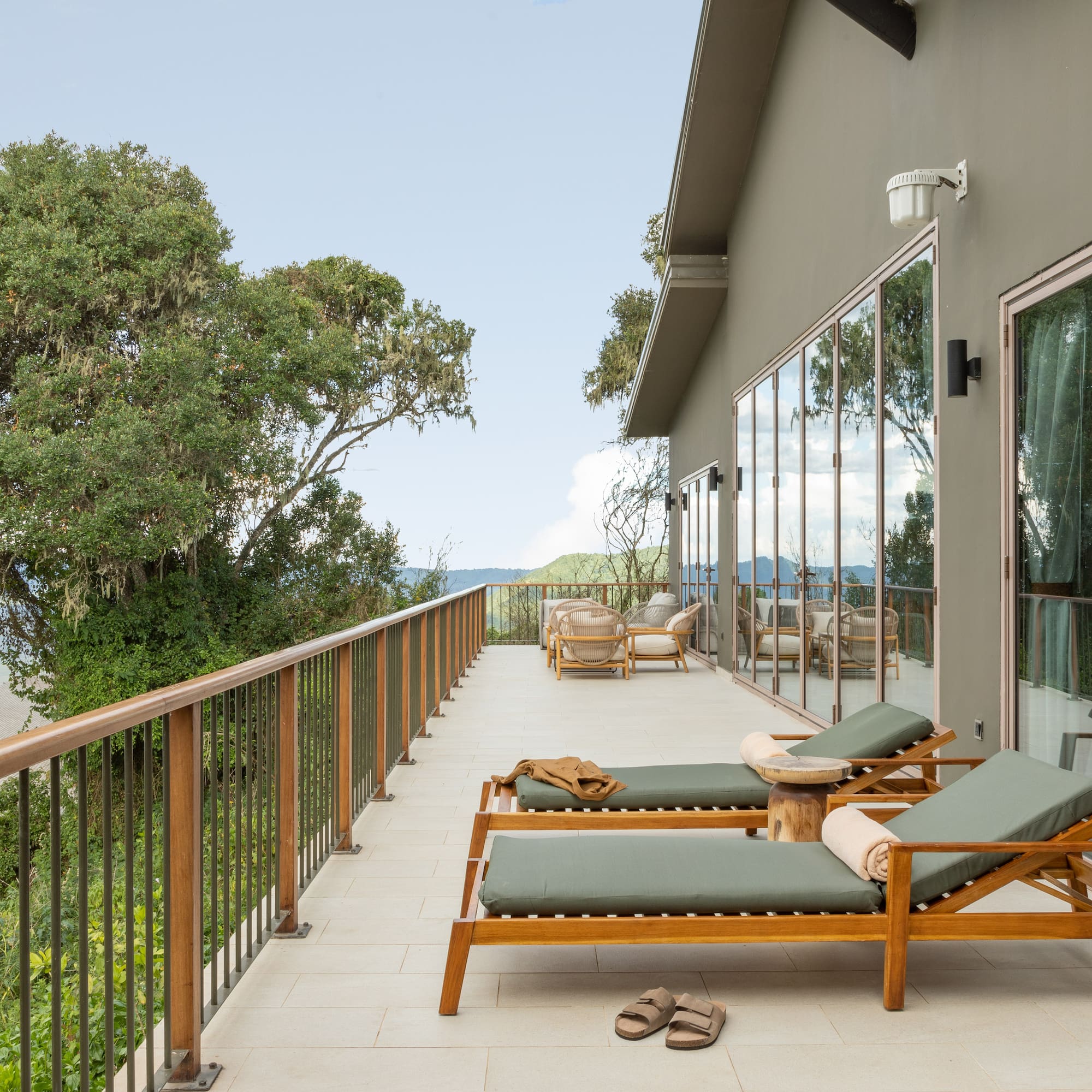 a deck with chairs and a railing