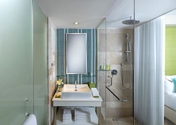 a bathroom with a mirror and shower