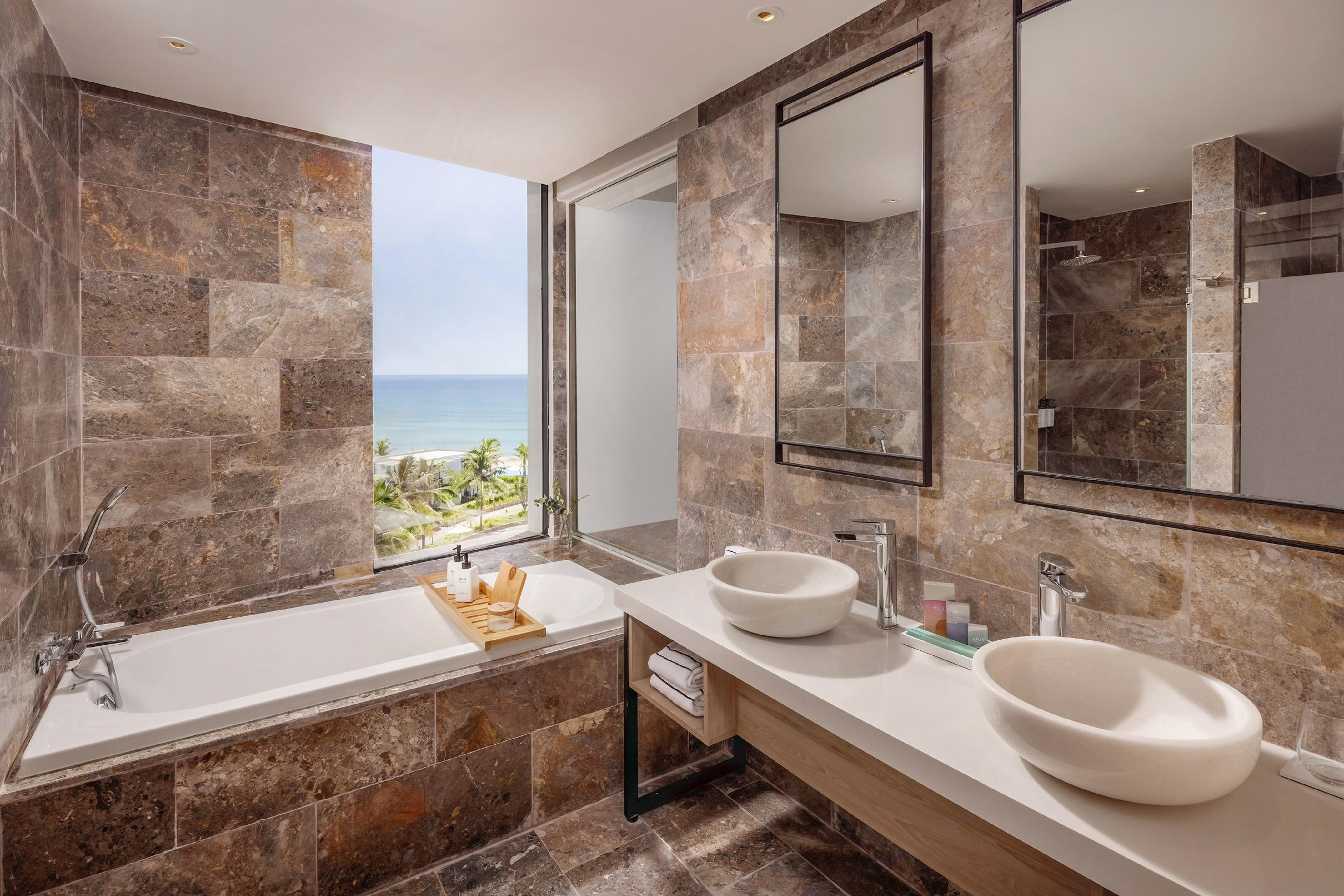 a bathroom with a bathtub and sinks
