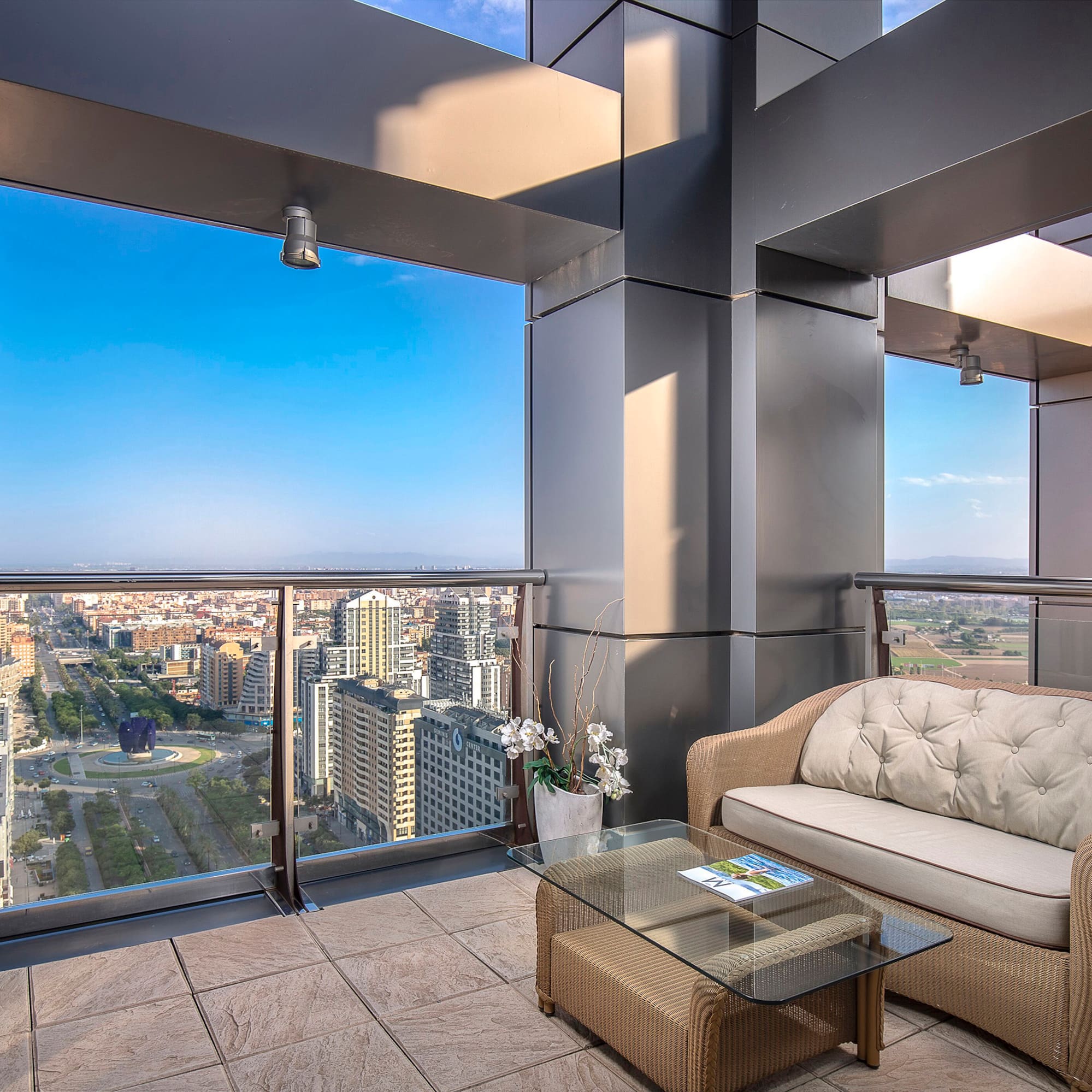 a balcony with a couch and a table