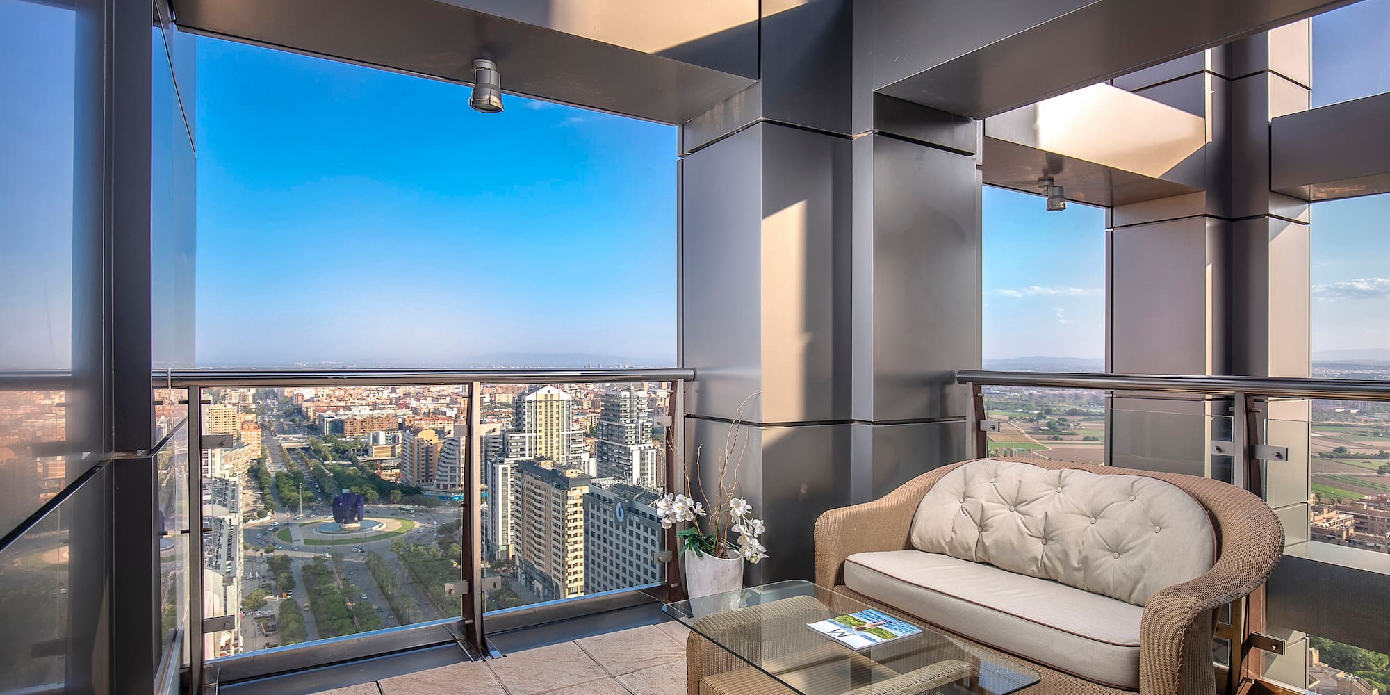 a balcony with a couch and a table