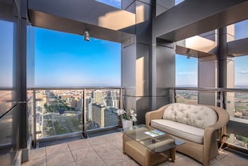 a balcony with a couch and a table