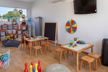 a room with a blackboard and table and chairs