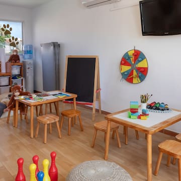 a room with a blackboard and table and chairs
