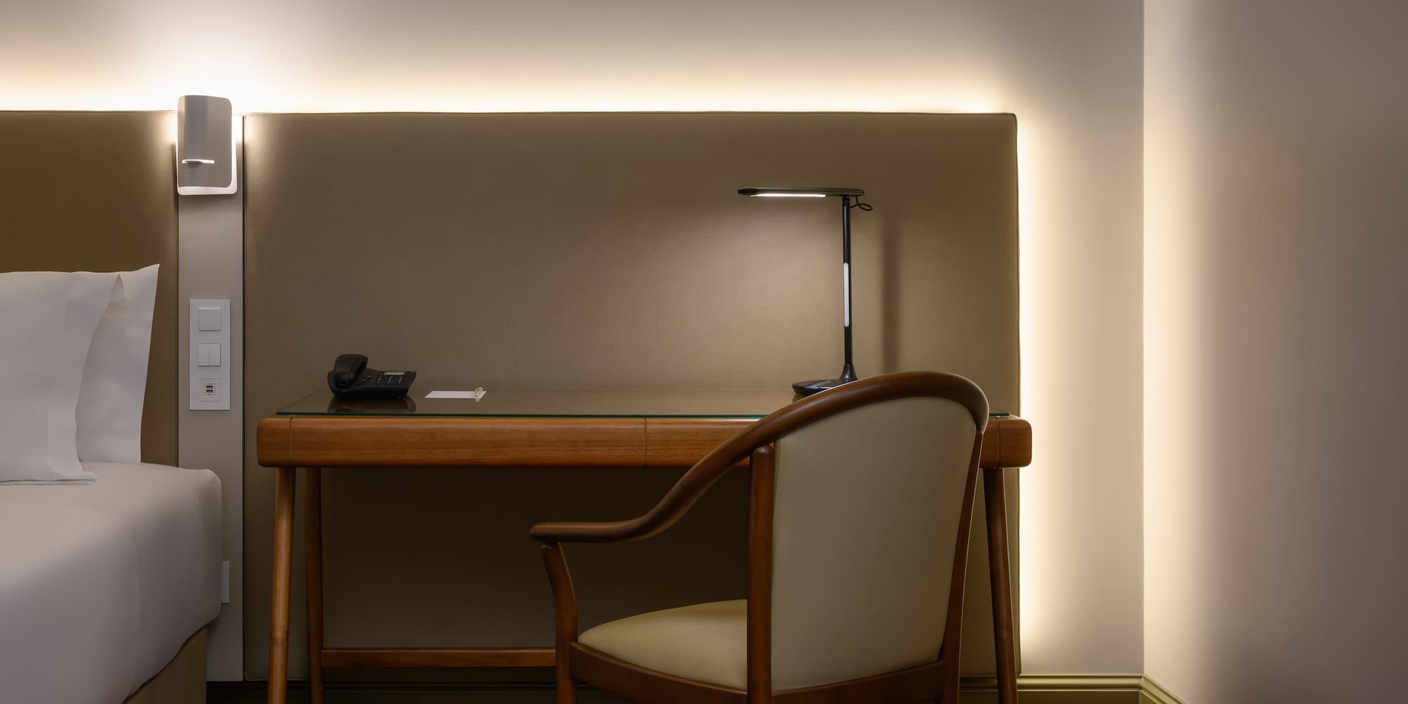 a desk with a chair and a lamp