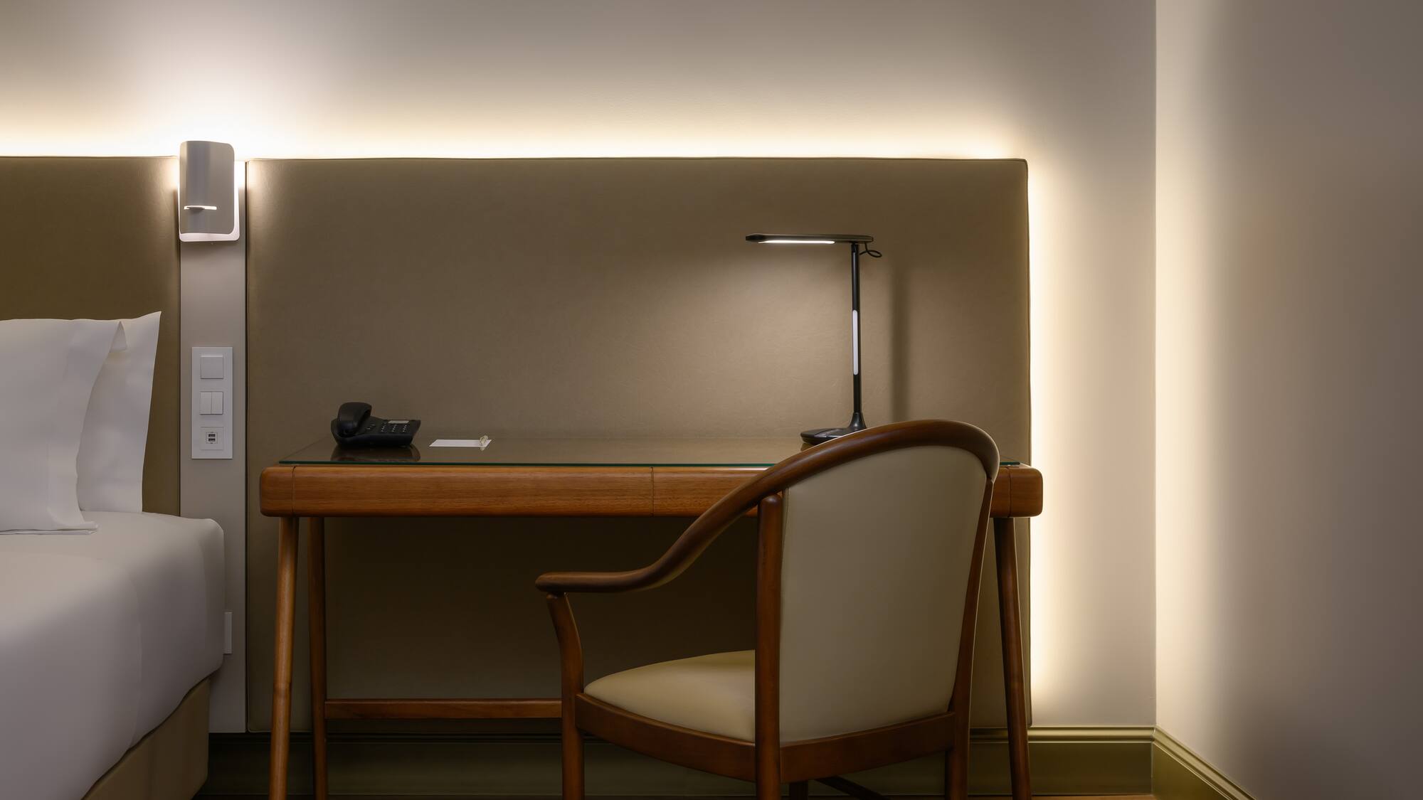 a desk with a chair and a lamp