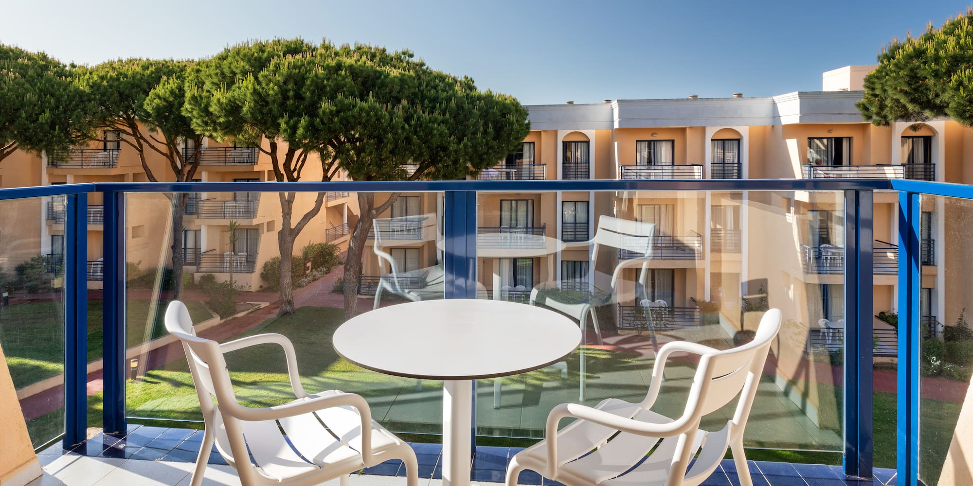 a table and chairs on a balcony