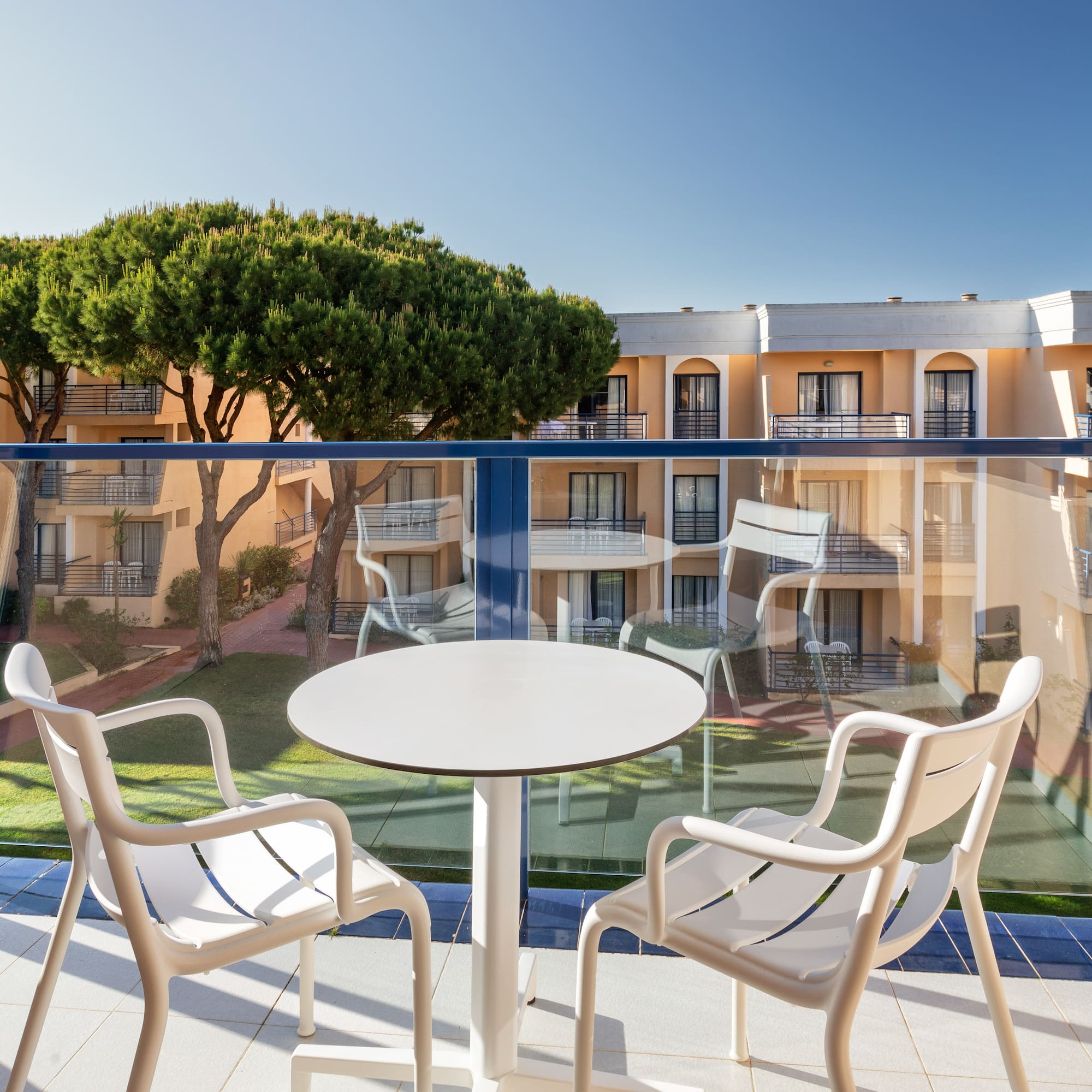 a table and chairs on a balcony