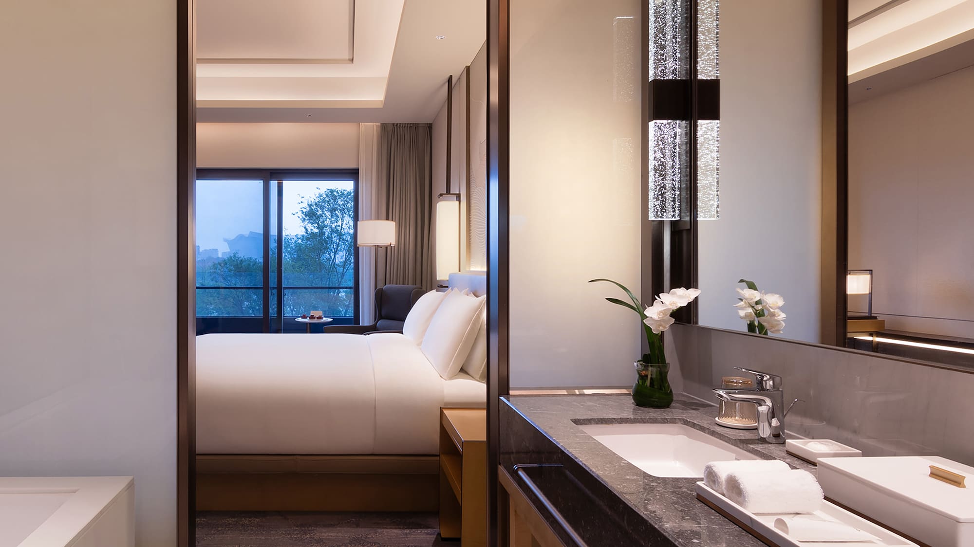 a bathroom with a bed and a mirror