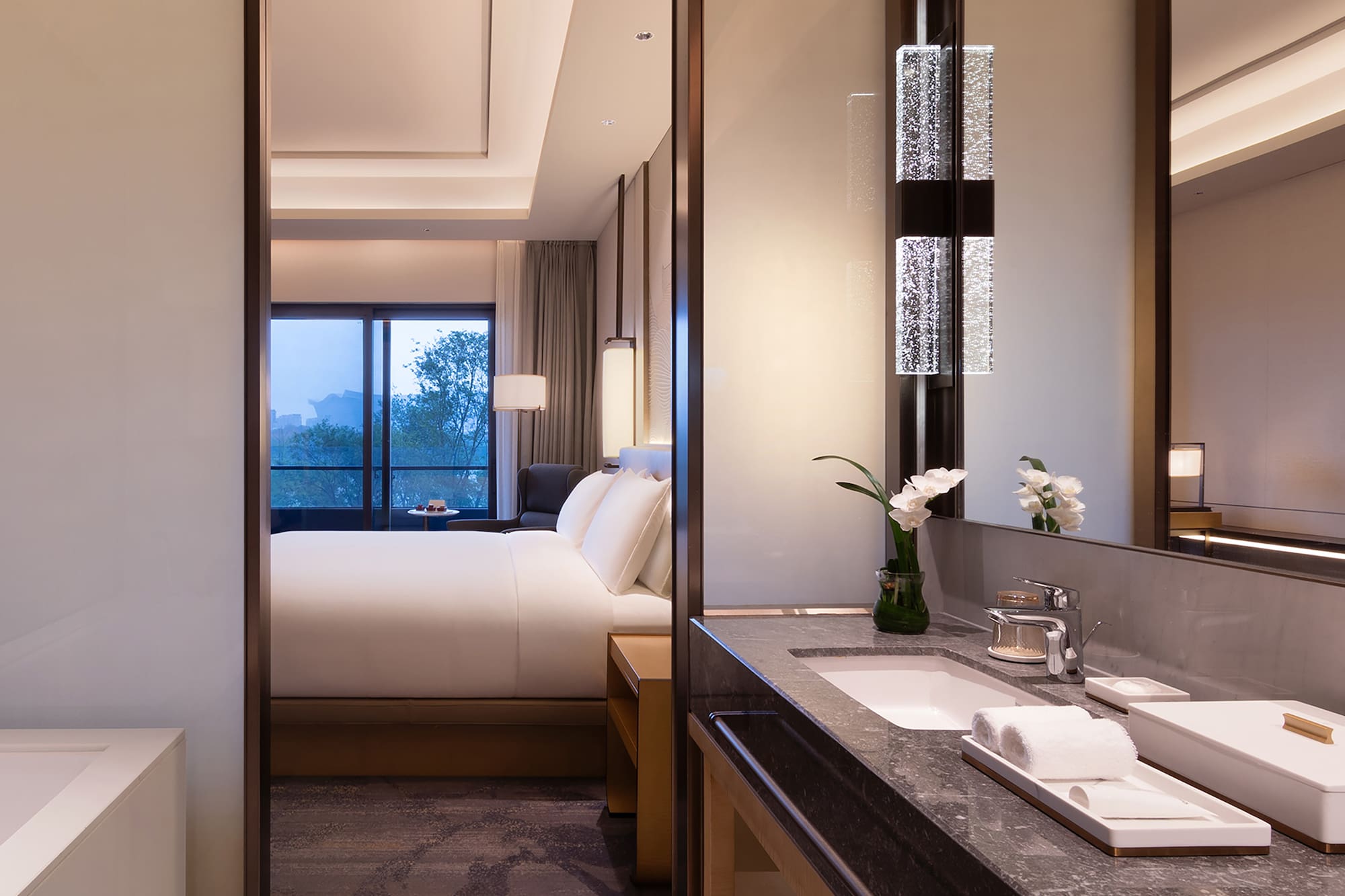 a bathroom with a bed and a mirror