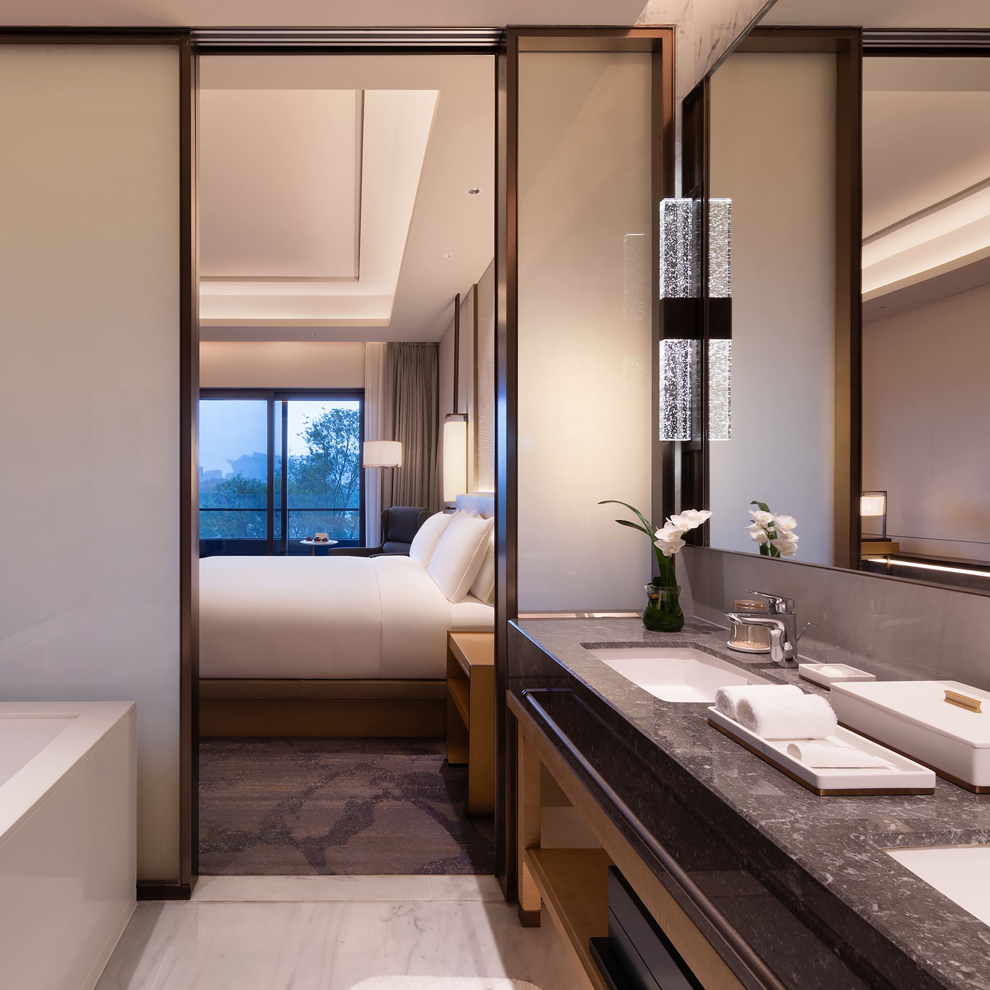 a bathroom with a bed and a mirror