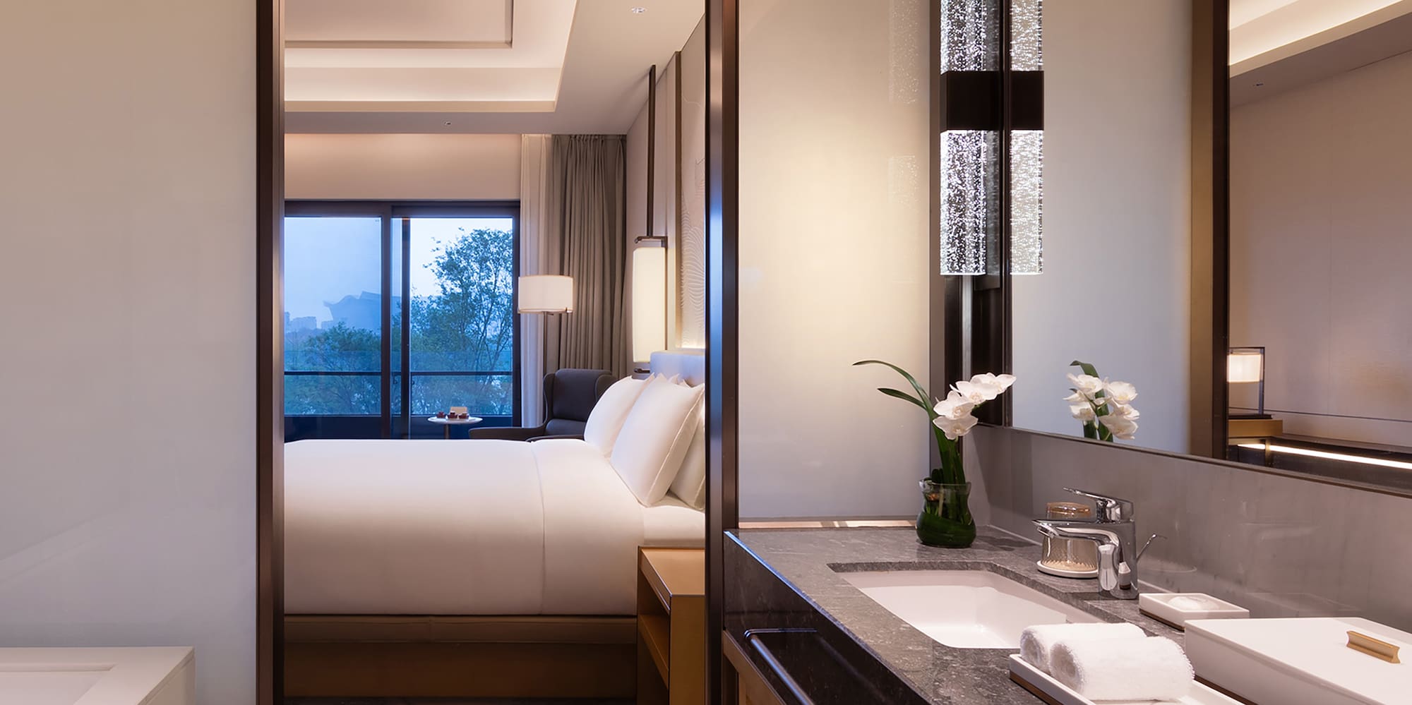 a bathroom with a bed and a mirror