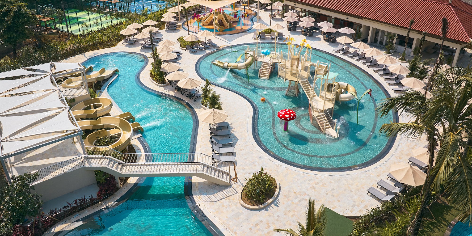 a swimming pool with slides and umbrellas