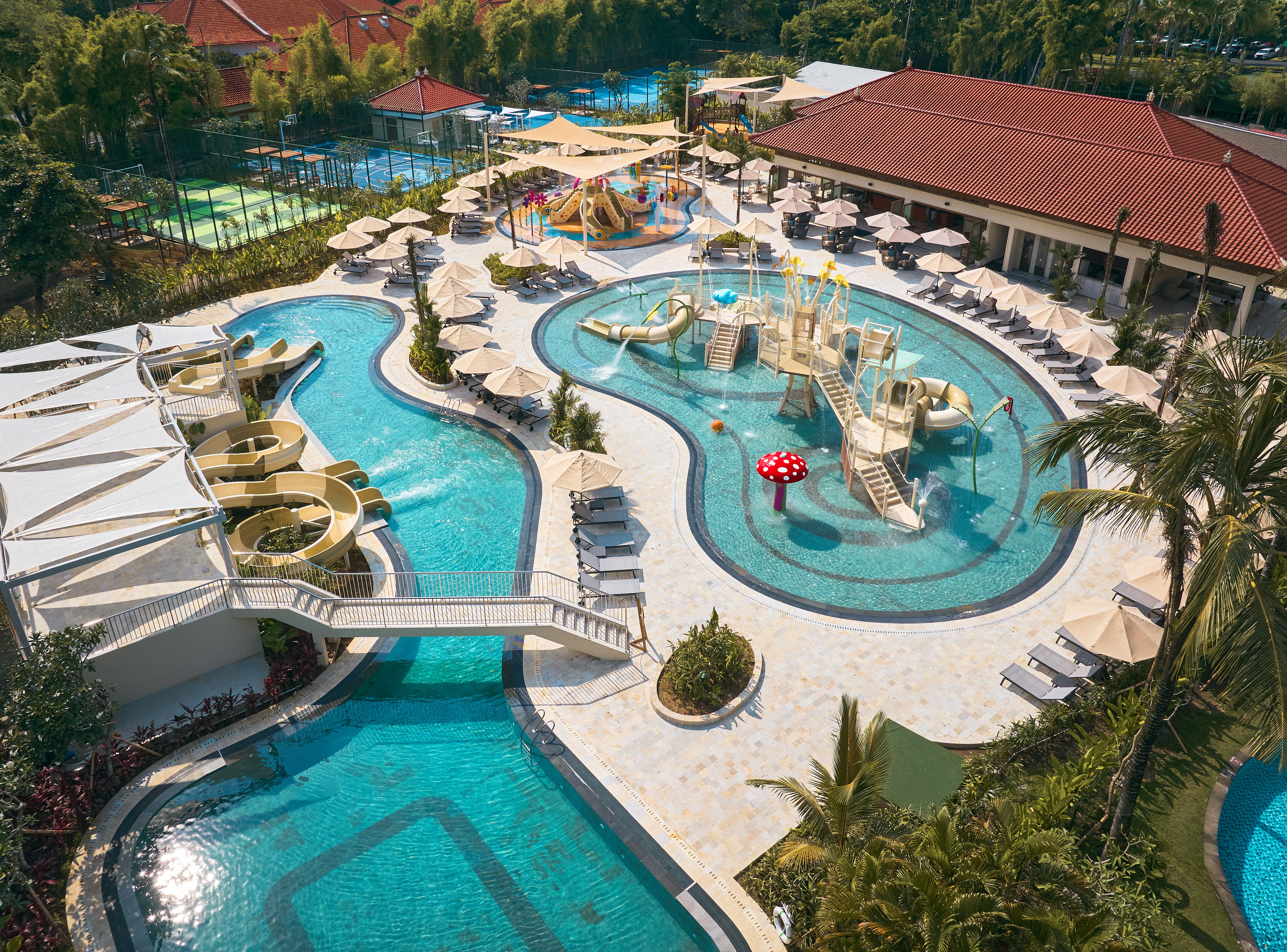 a swimming pool with slides and umbrellas
