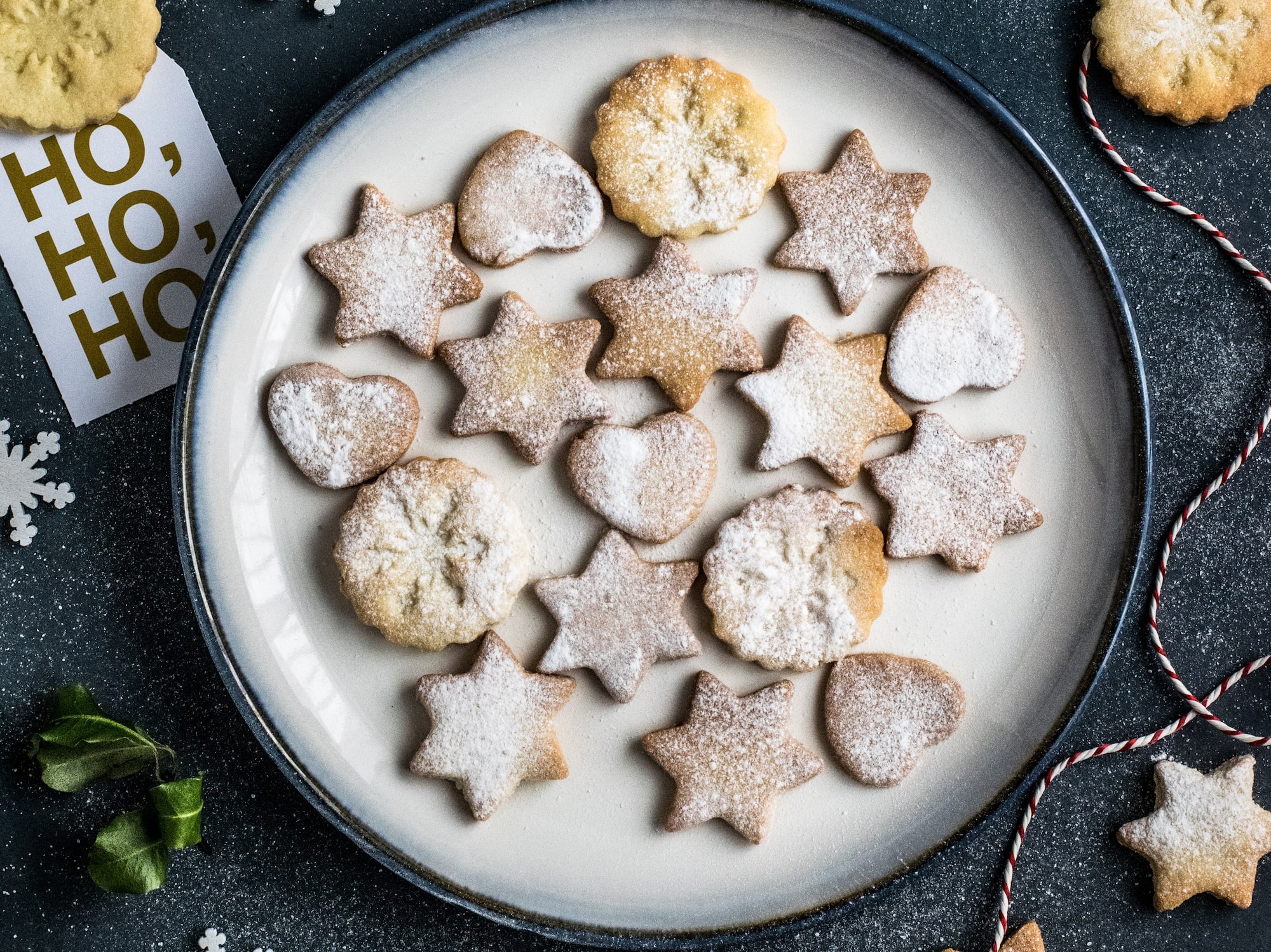 a plate of cookies and a string of snowflakes