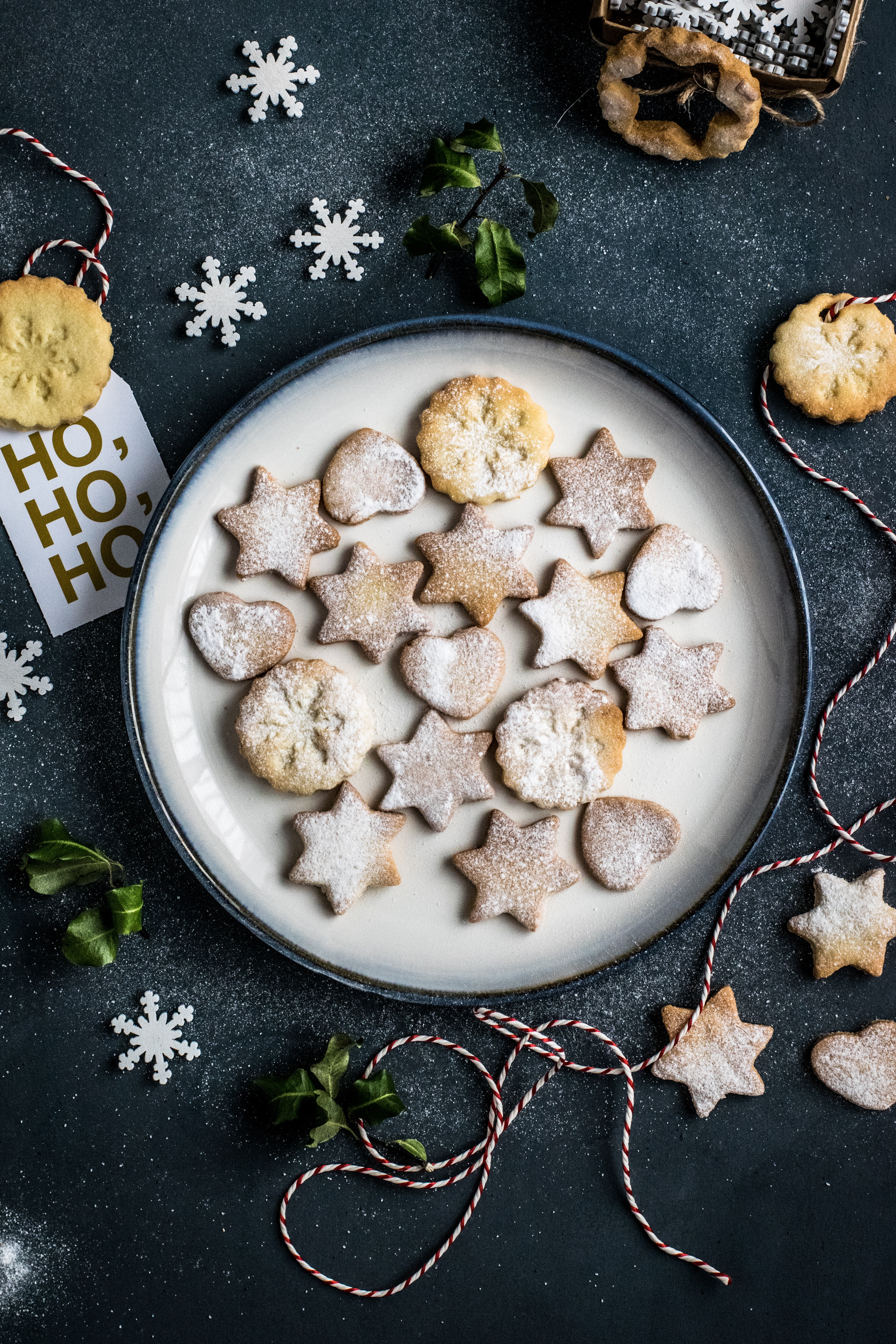 a plate of cookies and a string of snowflakes