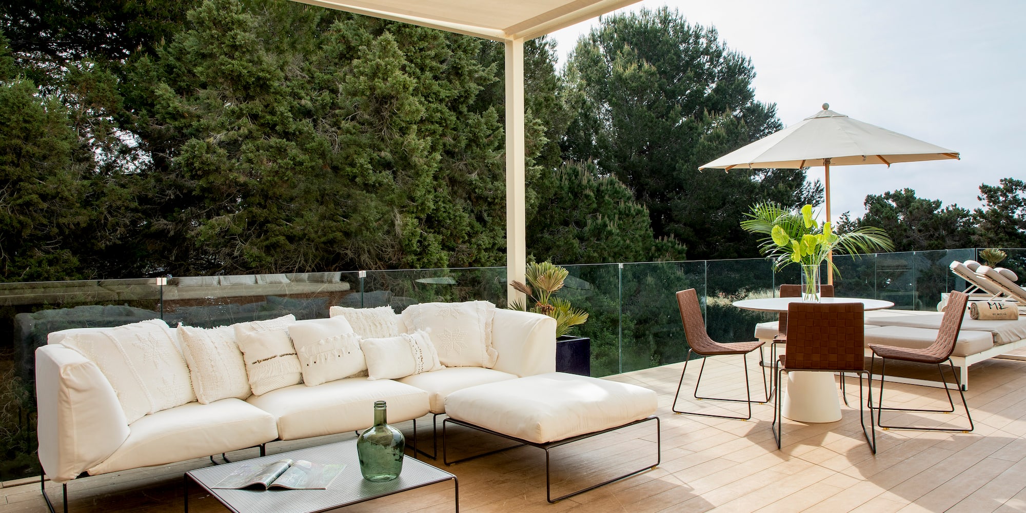 a patio with a white couch and a table