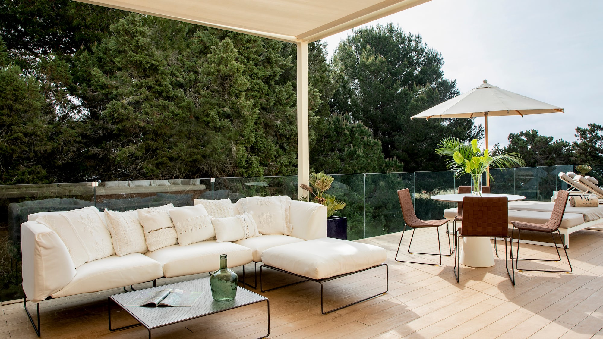 a patio with a white couch and a table