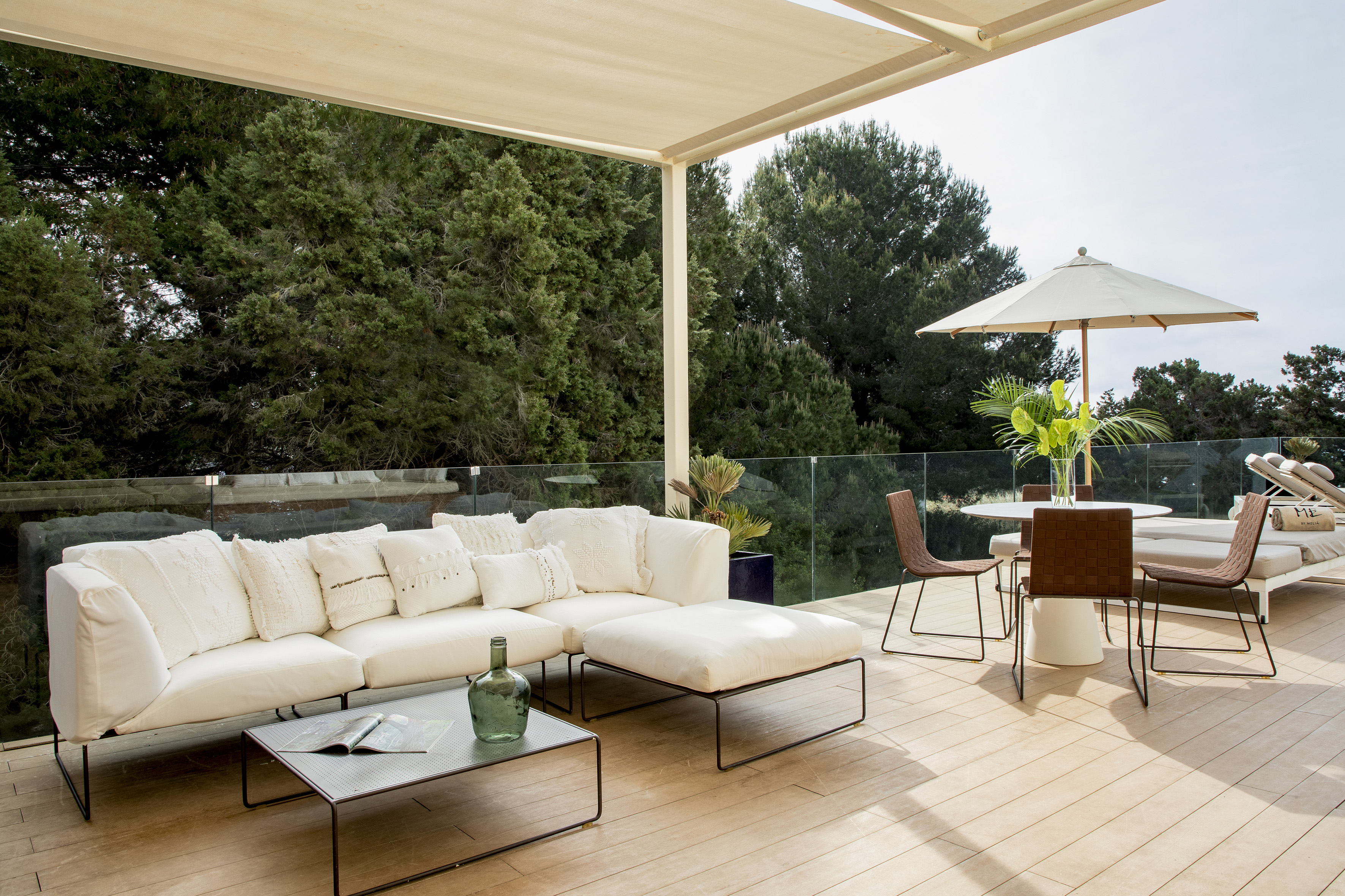 a patio with a white couch and a table