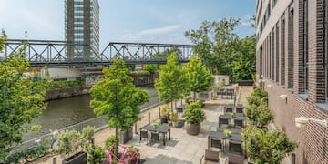 a river with tables and chairs