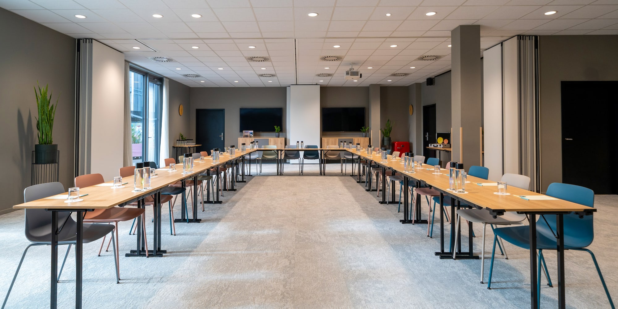a room with long tables and chairs